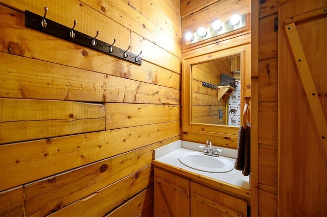 bathroom featuring vanity and wood walls