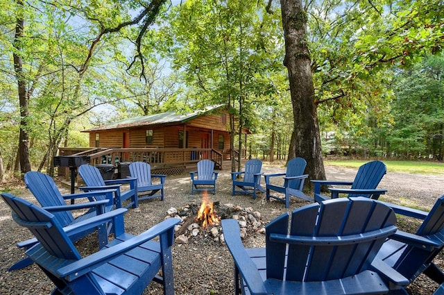 view of patio featuring a wooden deck and an outdoor fire pit