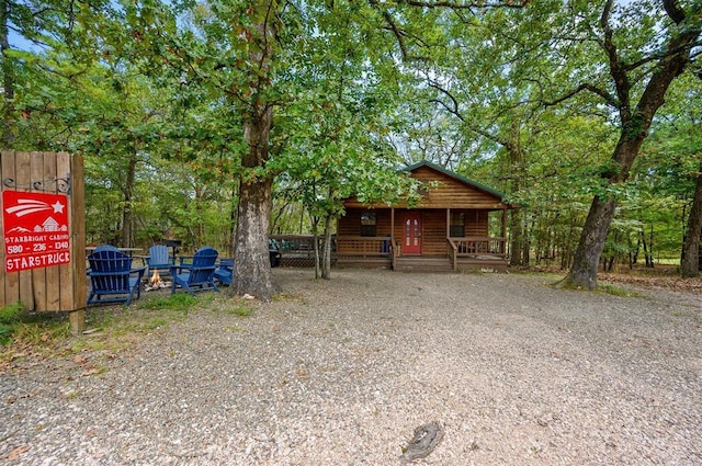 130 Wildwood Trl, Broken Bow, OK 74728 - rustic home featuring covered porch and log veneer siding