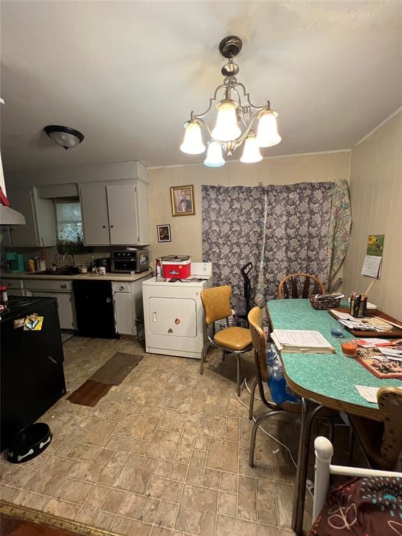 dining room with washer / dryer and an inviting chandelier