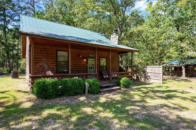 183 Pine Meadow Ln, Broken Bow, OK 74728 - view of front of property featuring a chimney, a metal roof, and a porch