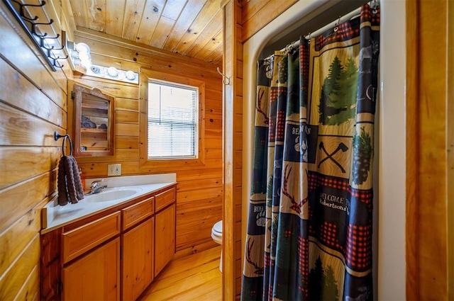 183 Pine Meadow Ln, Broken Bow, OK 74728 - bathroom featuring vanity, wooden walls, wood finished floors, wood ceiling, and a shower with shower curtain