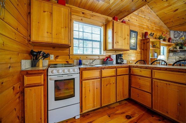 kitchen with sink, white electric range, dark hardwood / wood-style floors, wood walls, and vaulted ceiling