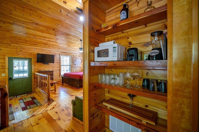 kitchen featuring wood walls and light hardwood / wood-style floors