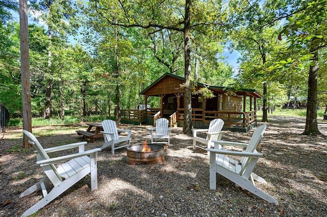 183 Pine Meadow Ln, Broken Bow, OK 74728 - view of yard featuring a fire pit, an exterior structure, and an outdoor structure