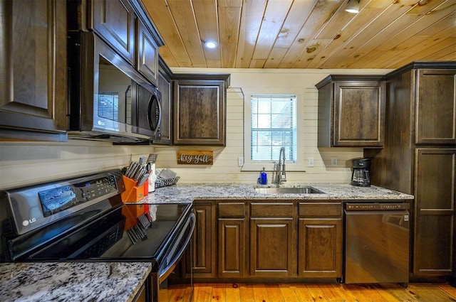 kitchen featuring light stone countertops, light wood-type flooring, sink, black appliances, and wooden ceiling