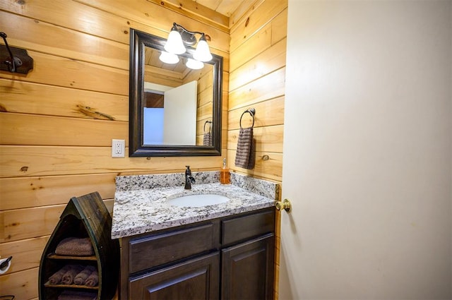 bathroom with wooden walls and vanity