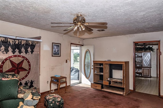 interior space with ceiling fan and a textured ceiling