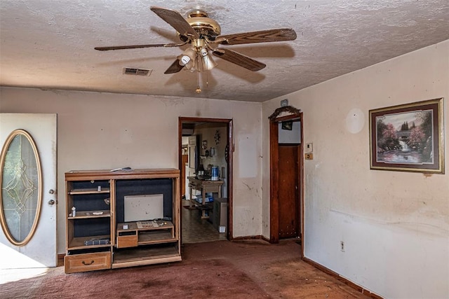 interior space featuring ceiling fan and a textured ceiling