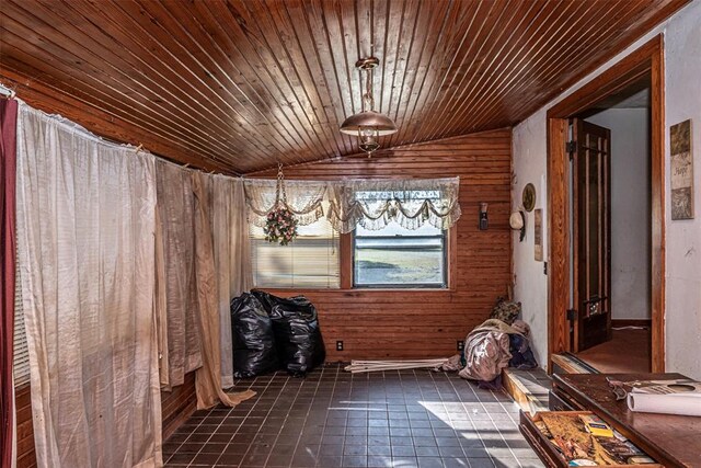 miscellaneous room featuring dark tile patterned flooring, wood walls, wood ceiling, and vaulted ceiling