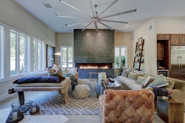 living room featuring ceiling fan and a fireplace