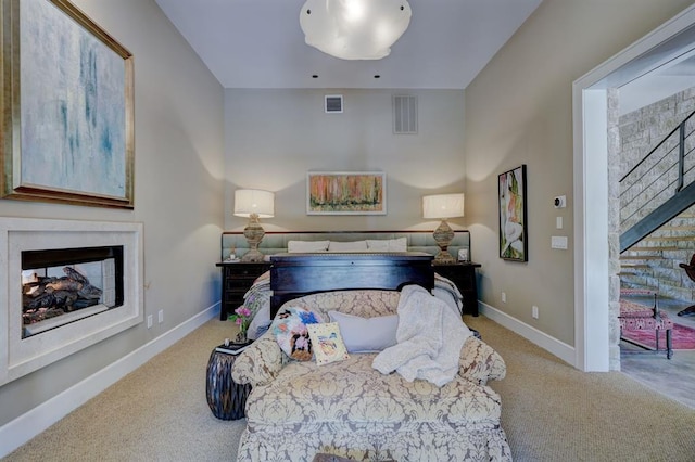 carpeted bedroom with a multi sided fireplace