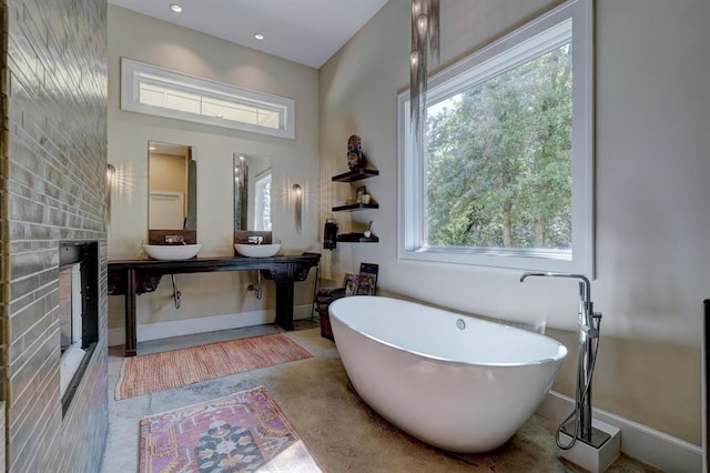 bathroom with vanity and a tub to relax in