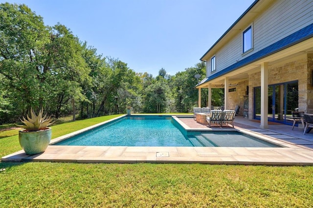 view of swimming pool with a yard and a patio