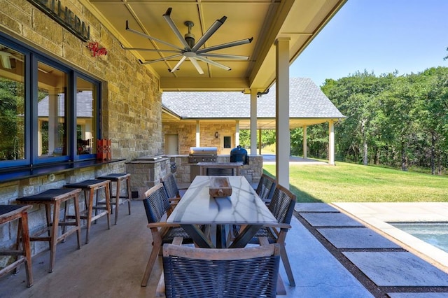 view of patio with ceiling fan and area for grilling