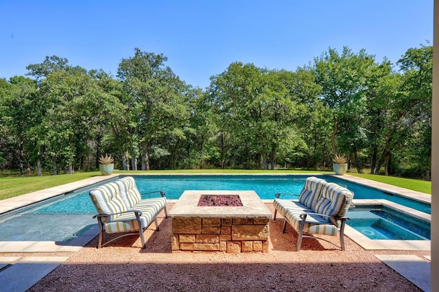 view of pool featuring an in ground hot tub and an outdoor fire pit