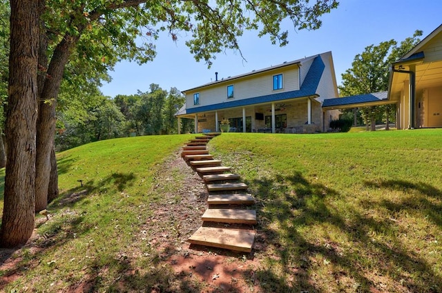 back of house with a lawn