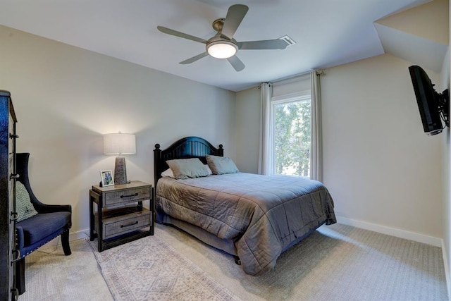 bedroom with ceiling fan, light carpet, and vaulted ceiling