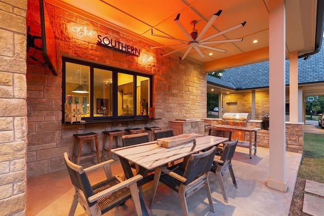 view of patio with area for grilling and ceiling fan