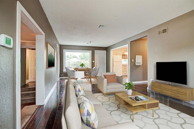 living room featuring hardwood / wood-style flooring and a textured ceiling