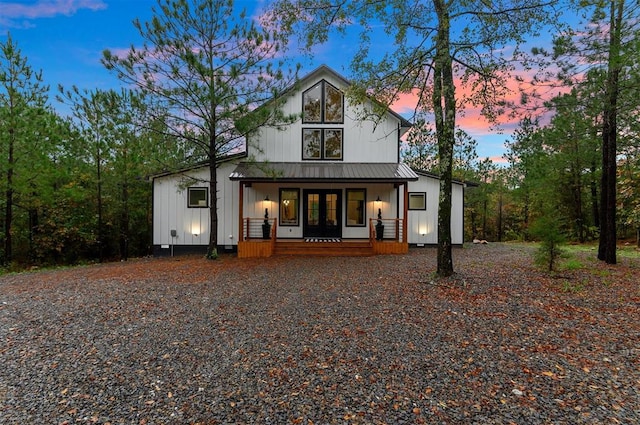 back house at dusk with covered porch