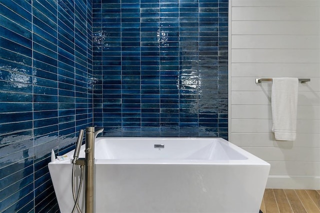 bathroom featuring hardwood / wood-style floors and a bath