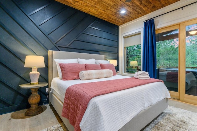 bedroom featuring hardwood / wood-style flooring, wood ceiling, and wood walls