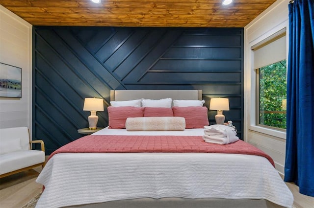 bedroom with wood walls, wooden ceiling, and wood-type flooring