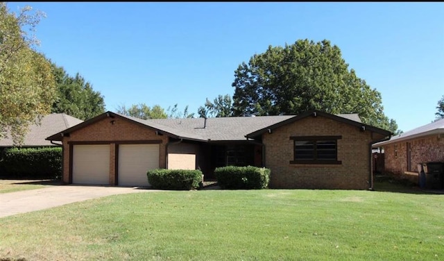 ranch-style home with a front yard and a garage