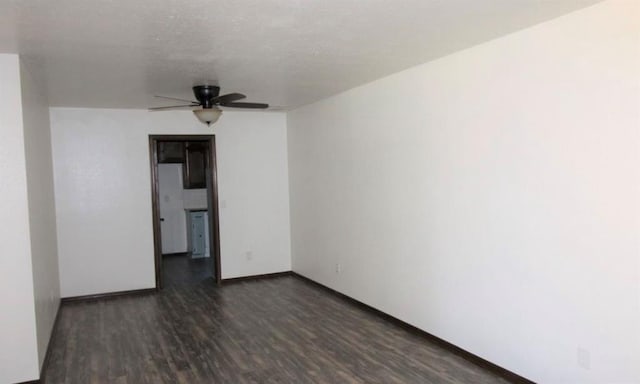 unfurnished room with dark hardwood / wood-style flooring and ceiling fan