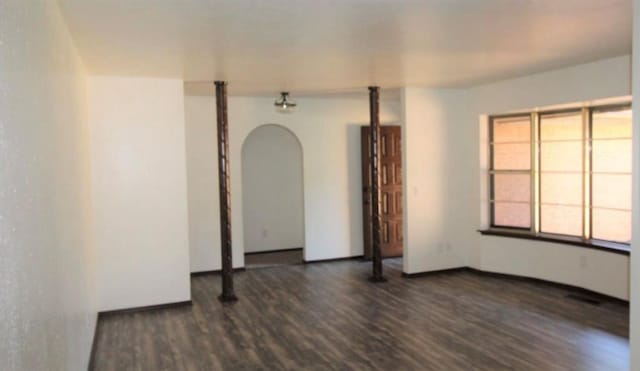 empty room featuring dark wood-type flooring