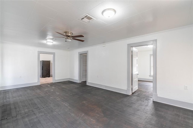 spare room featuring dark hardwood / wood-style floors and ceiling fan