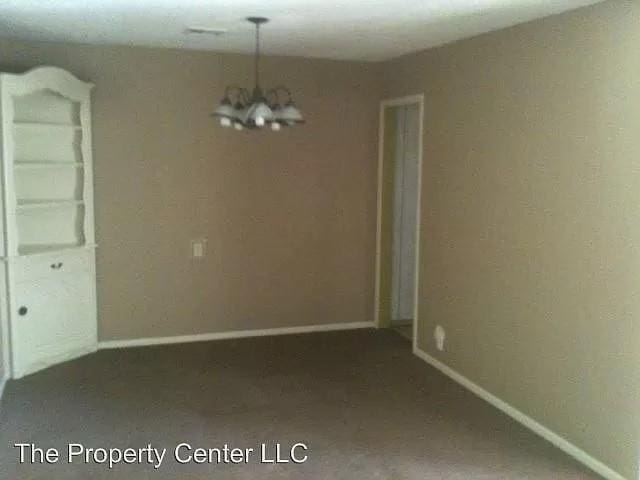 unfurnished dining area featuring a notable chandelier