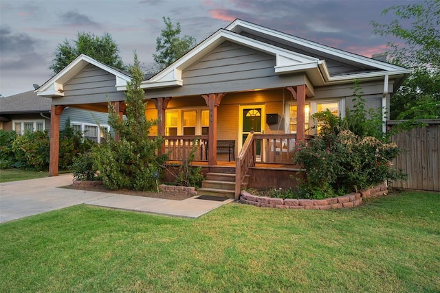 view of front of property featuring a yard and covered porch