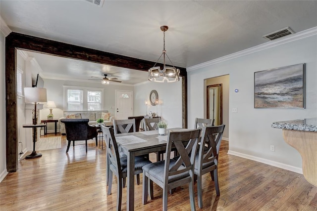 dining area featuring ceiling fan with notable chandelier, light wood-type flooring, and ornamental molding