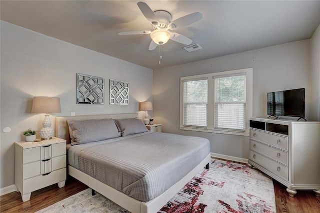 bedroom with ceiling fan and dark wood-type flooring