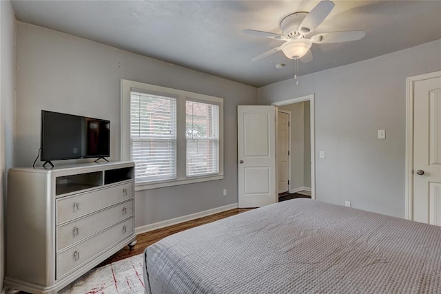 bedroom with ceiling fan and dark wood-type flooring