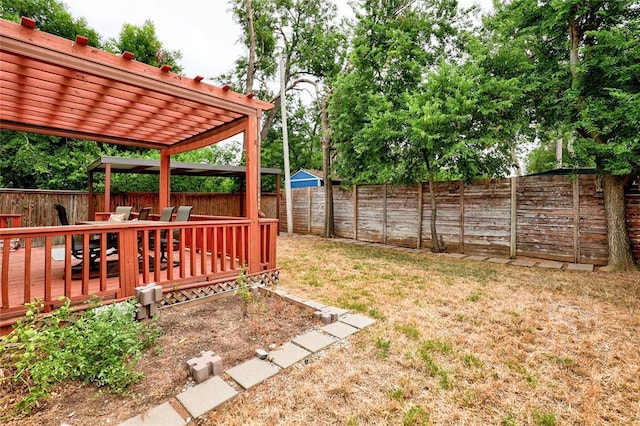 view of yard with a pergola and a deck