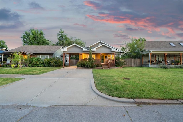 view of front facade featuring a yard, a porch, and a carport