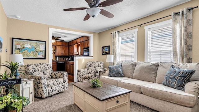 living room with a textured ceiling, ceiling fan, and light carpet