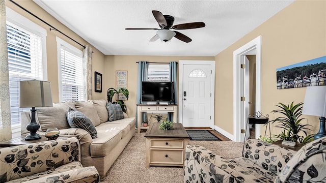 carpeted living room featuring ceiling fan