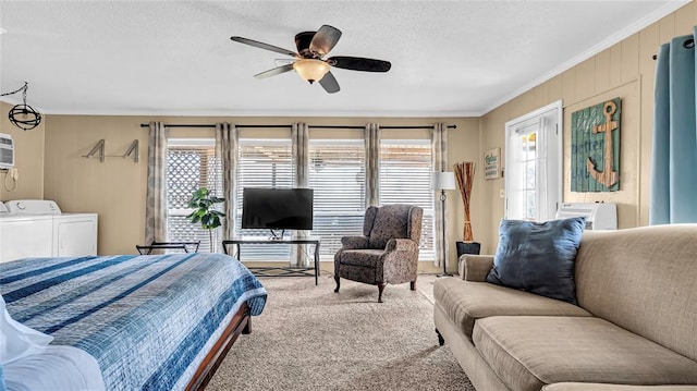 bedroom featuring carpet, ceiling fan, washing machine and clothes dryer, and multiple windows