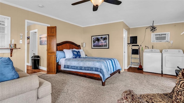 bedroom featuring hardwood / wood-style floors, an AC wall unit, crown molding, ceiling fan, and independent washer and dryer