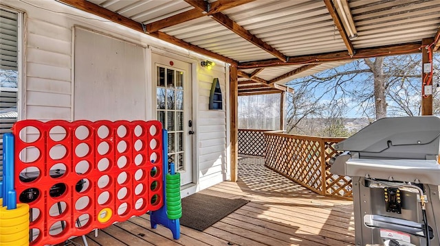 wooden deck featuring a grill