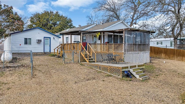 rear view of house with a wooden deck