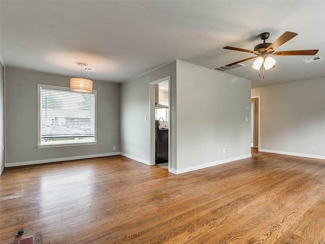 empty room featuring ceiling fan and wood-type flooring