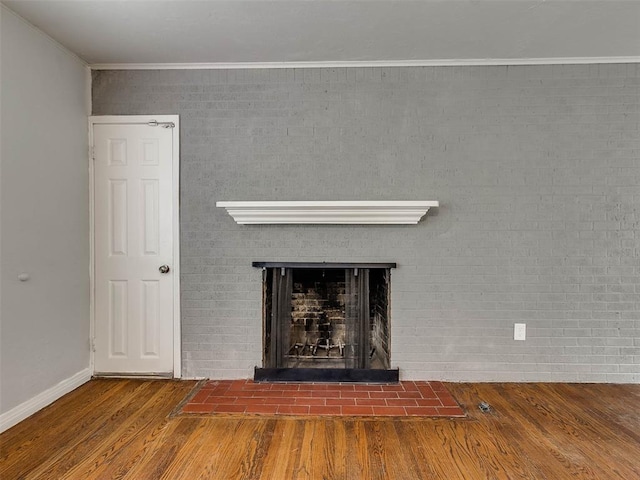 details with hardwood / wood-style flooring, ornamental molding, and a fireplace