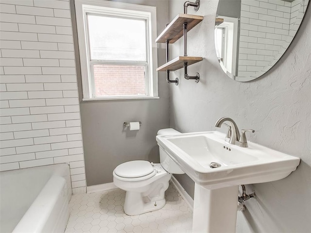 bathroom with toilet and tile patterned floors