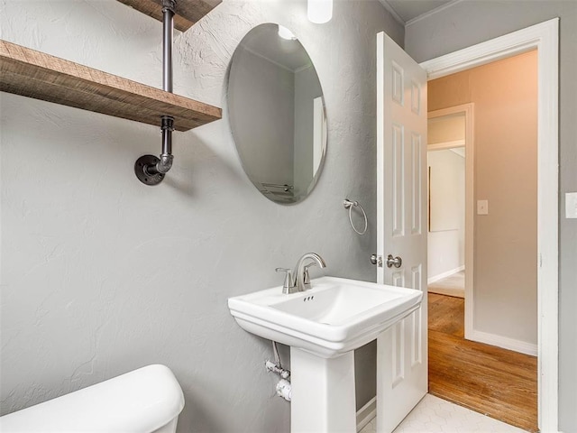 bathroom featuring sink, hardwood / wood-style floors, and toilet