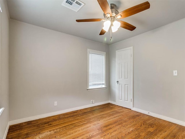 empty room featuring ceiling fan and hardwood / wood-style floors